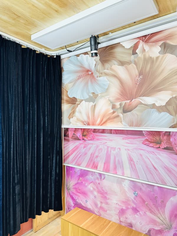 Custom floral backdrop wall inside a walk-in photo booth room